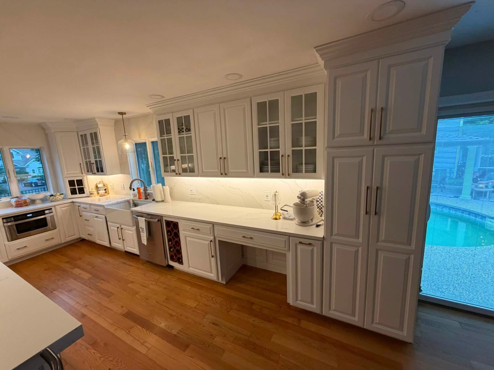 Remodeled kitchen with painted white cabinets, trim, and new countertops