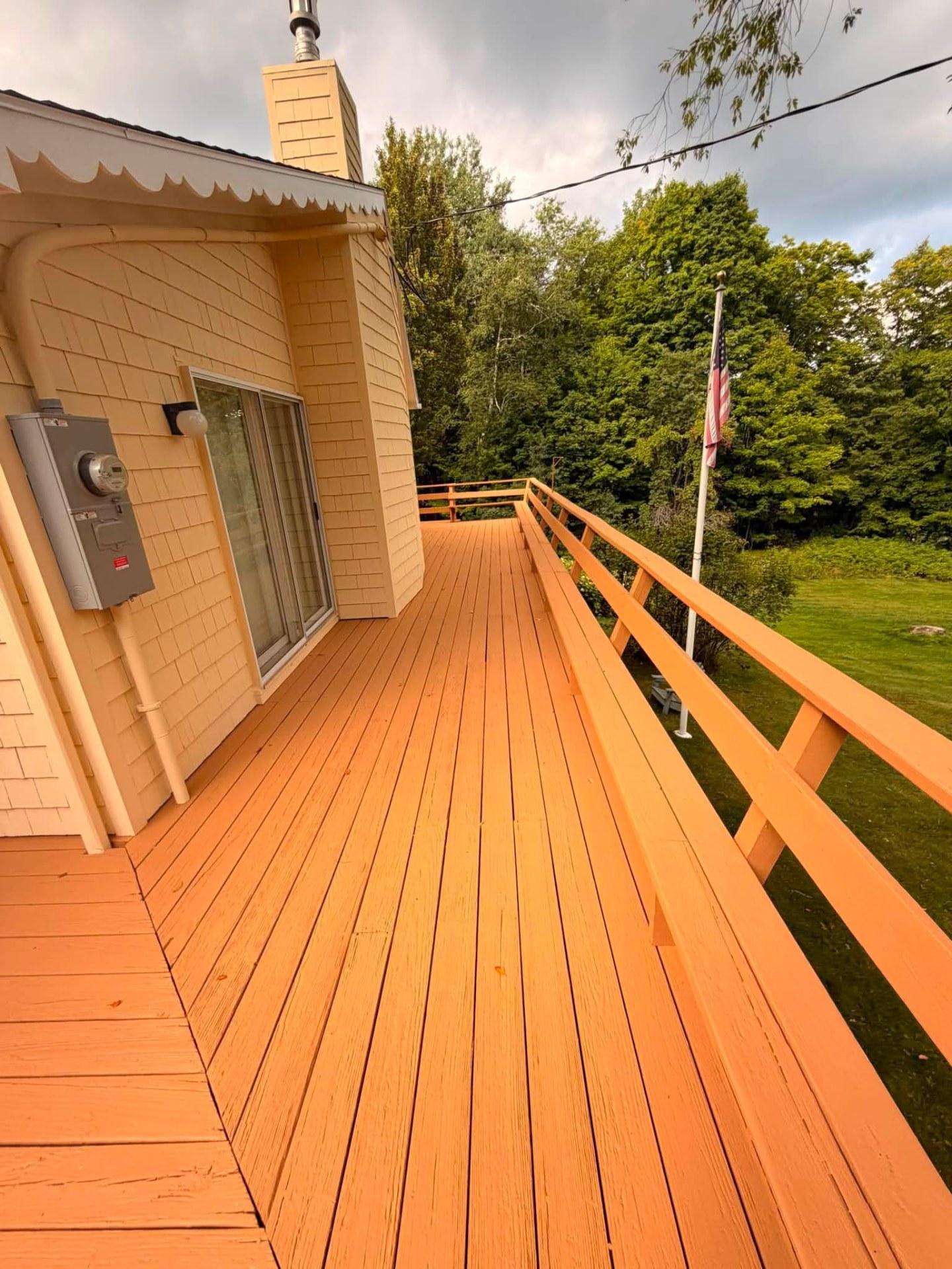 Deck boards and railings freshly painted and stained in a warm finish